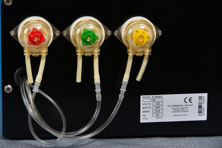 Close-up of the red, green and yellow pumps and tubing in the Radius Labs autosampler