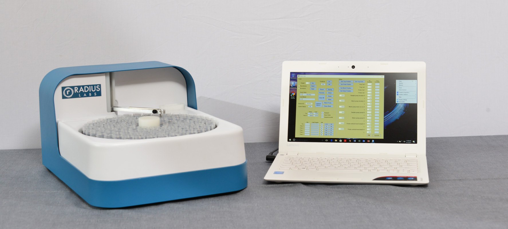 Radius Labs random access autosampler beside its control laptop